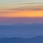 The picturesque mountain landscape on the sunset background